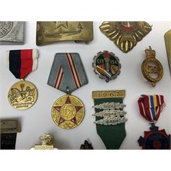 Collection of approximately sixty worldwide medals, metal badges, belt buckles, cloth badges, trench art, brass button stick etc