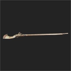 Indian Jezail style flintlock musket, with 118cm barrel, the East India Company lock marked 1818,  the curved butt inlaid with mother of pearl and brass decoration, overall L155cm