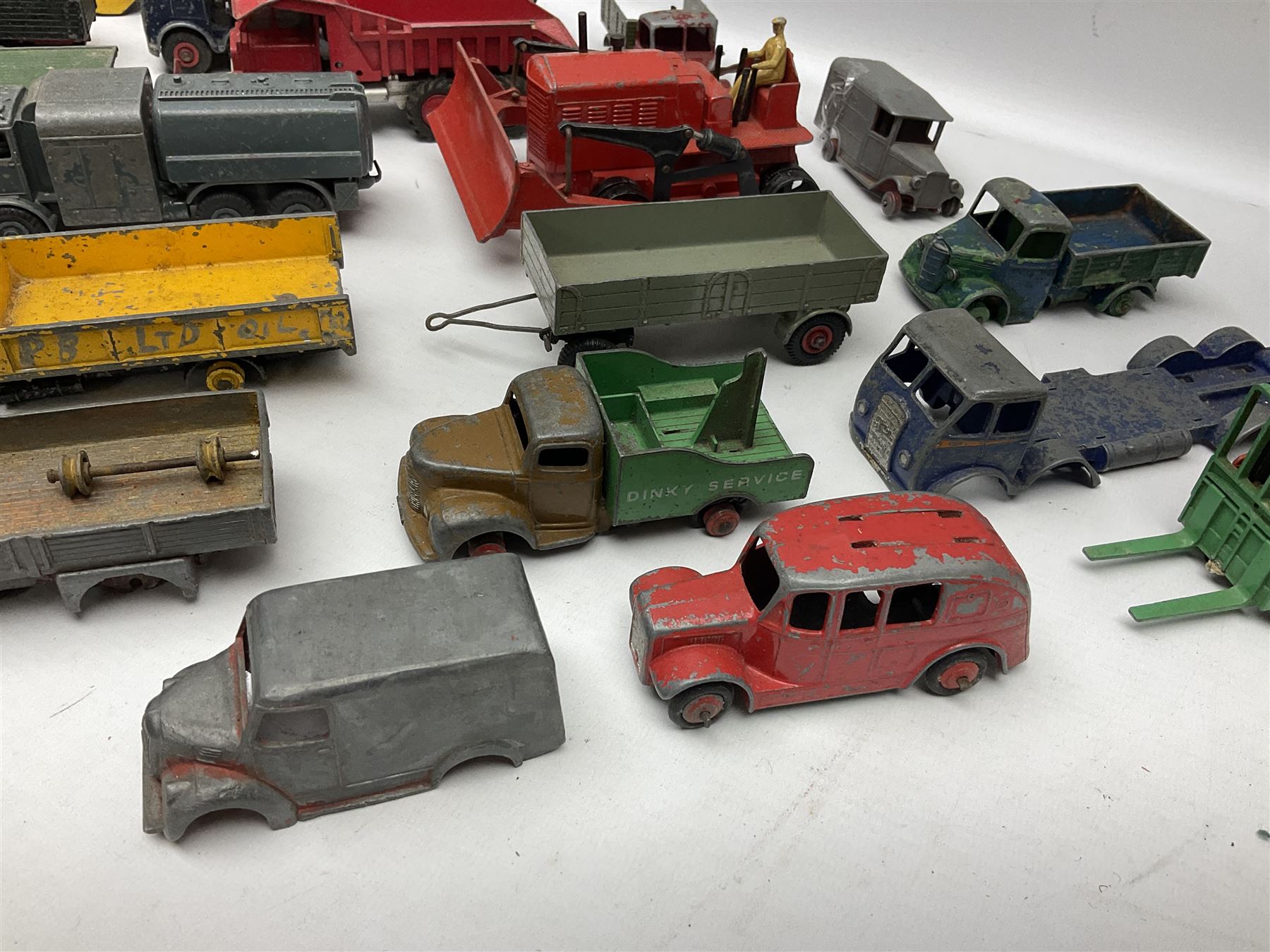 Dinky - twenty-six unboxed and playworn die-cast models including Foden Regent Tanker, two Foden lorries, Pressure Refueller No.642, Snow Plough, Elevator Loader, Foden Dump Truck, Blaw Knox Bulldozer and other commercial vehicles