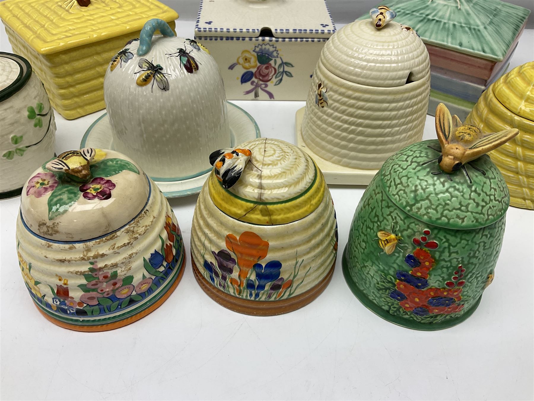 Clarice Cliff for Wilkinson Ltd Crocus Bizarre beehive honeypot painted in the Crocus pattern, together with two beehive Beswick honey pots, Poole square honey pot etc (14)