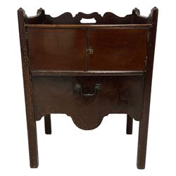 George III mahogany tray top night-cabinet commode, the three quarter gallery with pierced handle back, the rectangular sliding top over two front cupboard doors, opening to reveal hinged lid enclosing the washbasin and bowl rest