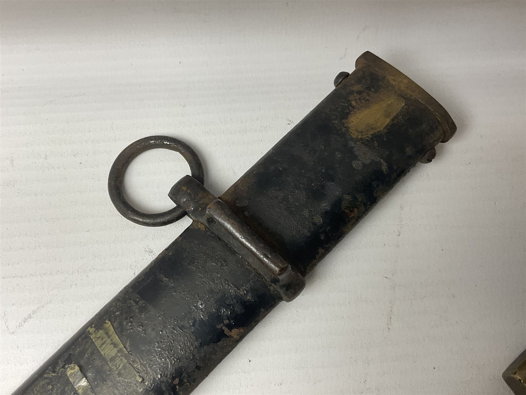 Prussian artillery officer's sword, with 80cm slightly curving fullered  blade, brass hilt with D-shaped langets, curving knucklebow, wire-bound black grip and leather finger loop; in black painted steel scabbard with single suspension loop