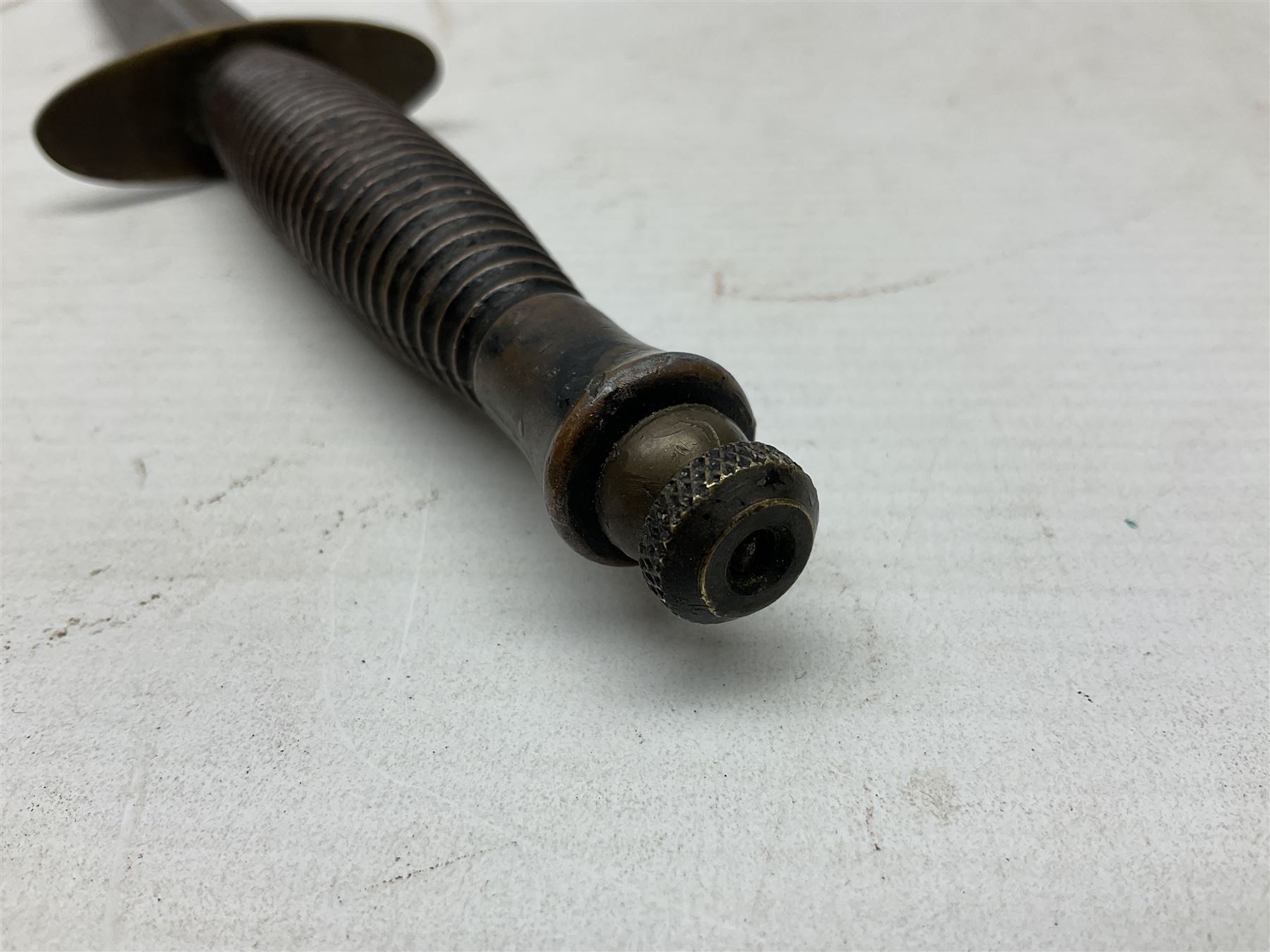 Fairburn and Sykes Commando fighting knife, 3rd pattern with 17cm double edged blade and copperised grip; no markings; in cut-down plain leather sheath L31.5cm