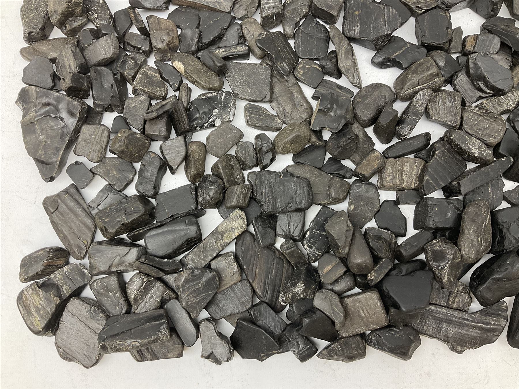 Collection of raw Whitby jet including large piece with one polished side, approx 4lbs