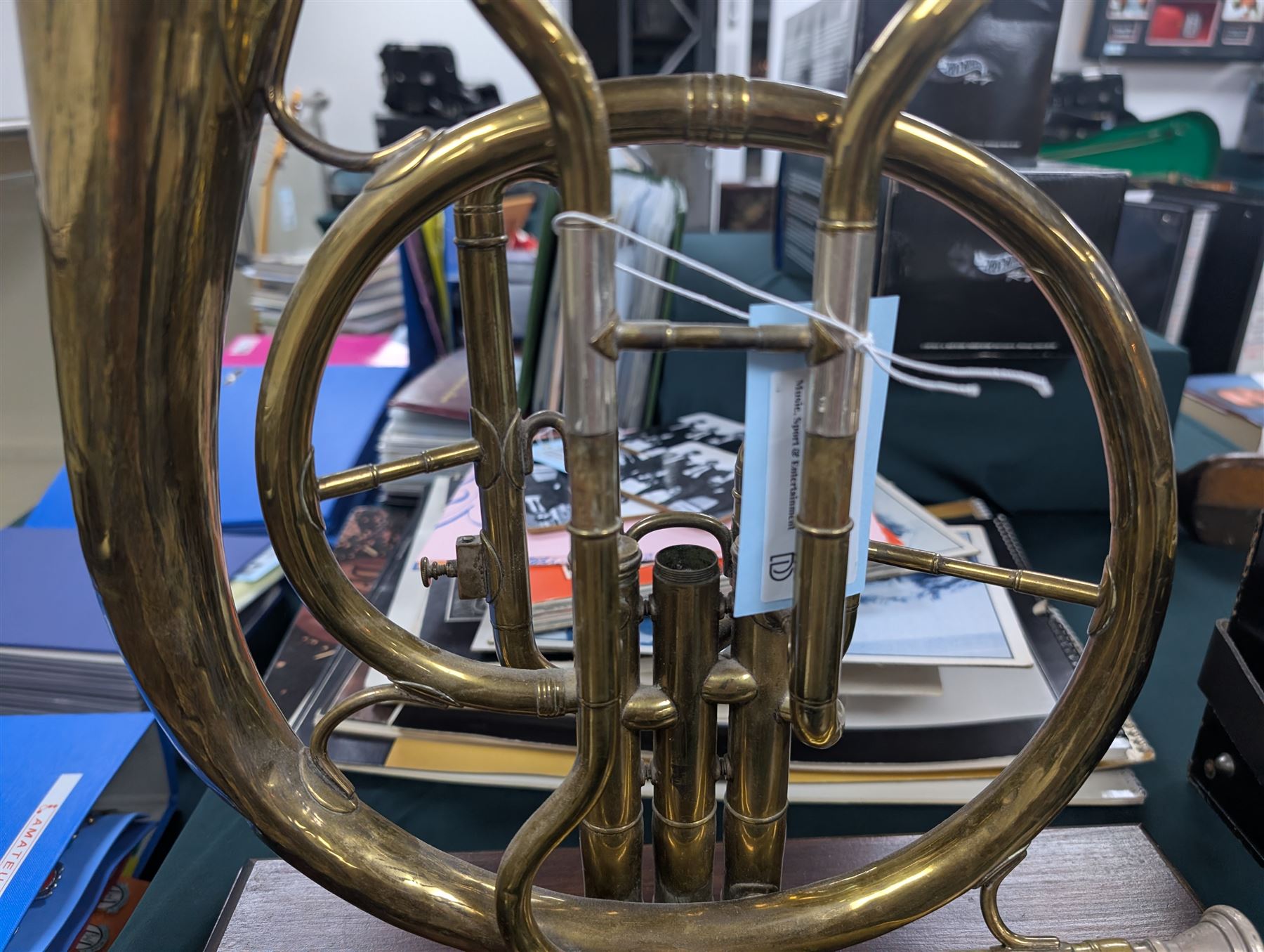 Boosey & Co Ltd French horn, converted into a table lamp, upon a wooden plinth, H45cm