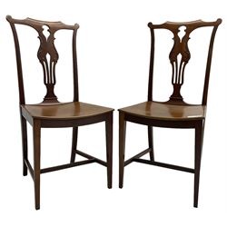 Early 20th century pair of mahogany side chairs, shaped cresting rail over shaped and pierced splat carved with curled leaf decoration, dished seat on square tapering supports united by H-stretchers 