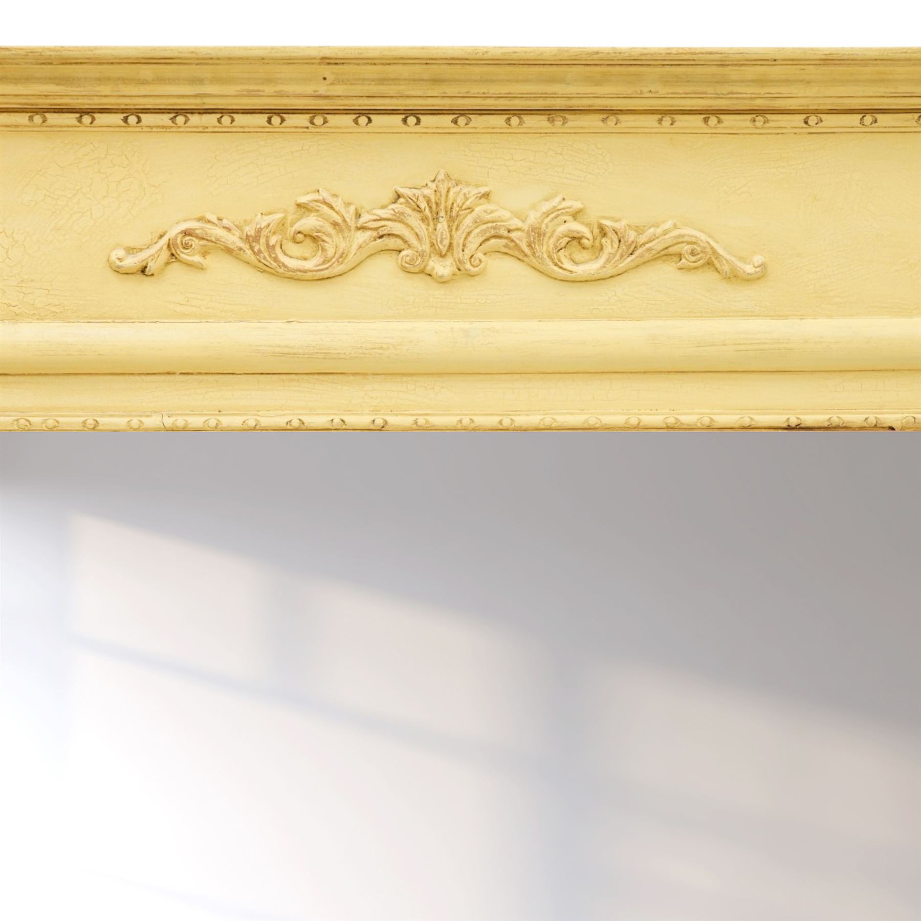 Traditional design cream painted overmantle mirror, projecting cornice with applied foliate detail, bevelled glass plate 