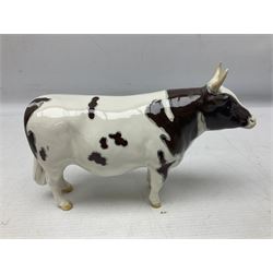 Five Beswick figures of cattle Comprising Ayrshire Bull Ch Whitehill Mandate, no 1454B, three Ayrshire Cow Ch Ickham Bessie, no 1350 and Ayrshire Calf, no 1249B, all with printed marks beneath