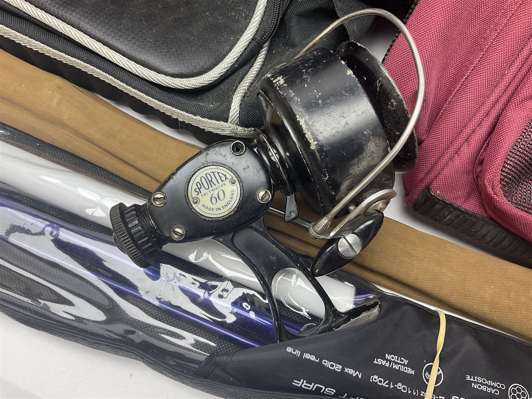 Collection of fishing memorabillia and equipment, including an Allcocks three piece split cane trout fly rod, Shakespeare Salt 3600 surf rod, two tackle bags, Old Red Seastreak multiplier reel, Sportext Saltwater fixed spool reel, fishing dvds, etc