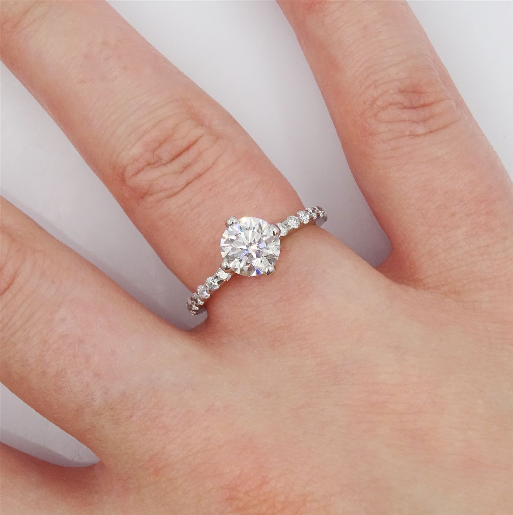 Platinum single stone round brilliant cut diamond ring, with diamond set shoulders and diamond set gallery, principal diamond approx 1.00 carat