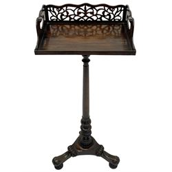 Regency style hardwood book tray on stand, the tray with pierced fretwork back and handle pierced sides, turned tapered column carved with foliate baluster, on triangular platform carved with scrolls, turned and lobe carved feet