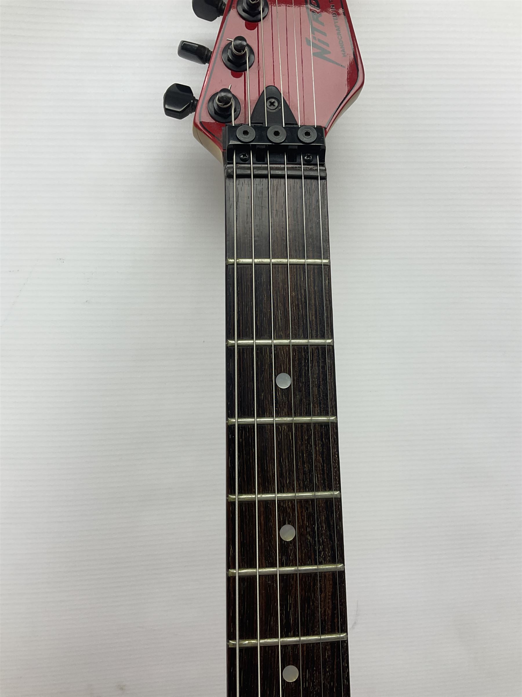 American Peavey Nitro 1 hand-made electric guitar in red with Kahler tremolo, serial no.02786479, L98cm overall; in soft carrying case.