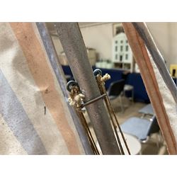 Large pond yacht with simulated planked mahogany deck, mahogany hull, wooden keel and stern fin and tubular aluminium mast with two sails; on wooden stand L131cm H on stand 177cm