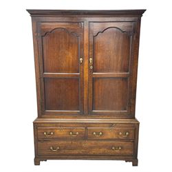 George III oak livery cupboard, projecting moulded cornice over two panelled doors, the upper panels within stepped ogee and arched moulded frame, the interior fitted with a single row of wooden hooks, two short and one long drawers, on bracket and return skirted base 