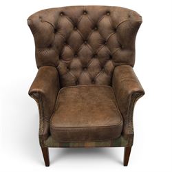 Pair of Georgian design wingback armchairs upholstered in brown leather and tartan tweed fabric, button back and scrolled arms with brass studded trim, square tapered supports