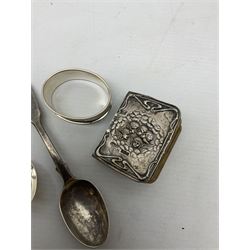 Miniature common prayer book with silver relief moulded covers decorated with putti and gilt edges, hallmarked Green and Cadbury Ltd, Birmingham 1906, together with two hallmarked teaspoons and engine turned napkin ring, total weighable silver weight approx 43.4g