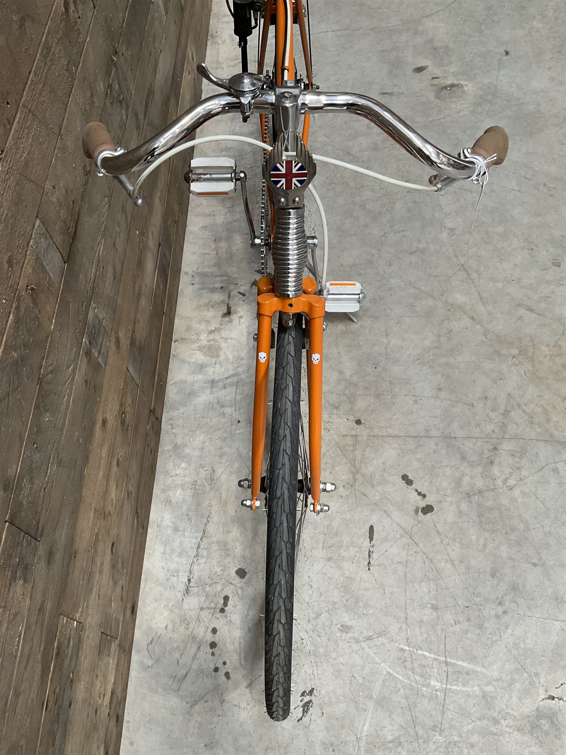 Fully restored vintage advertising bicycle with 2 stroke petrol engine, orange frame, tan leather seat