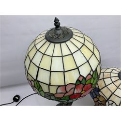 Tiffany style lamp in the form of a semi nude woman holding up a leaded lampshade together with a similar table lamp