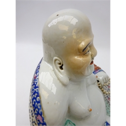  20th century porcelain figure of Hotei, seated wearing flowing robes, holding beads in his right hand with pierced decoration, impressed seal mark to base, H26cm x W24cm   