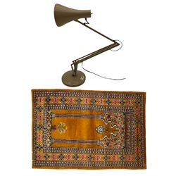 Angle-poise lamp and an Islamic prayer mat