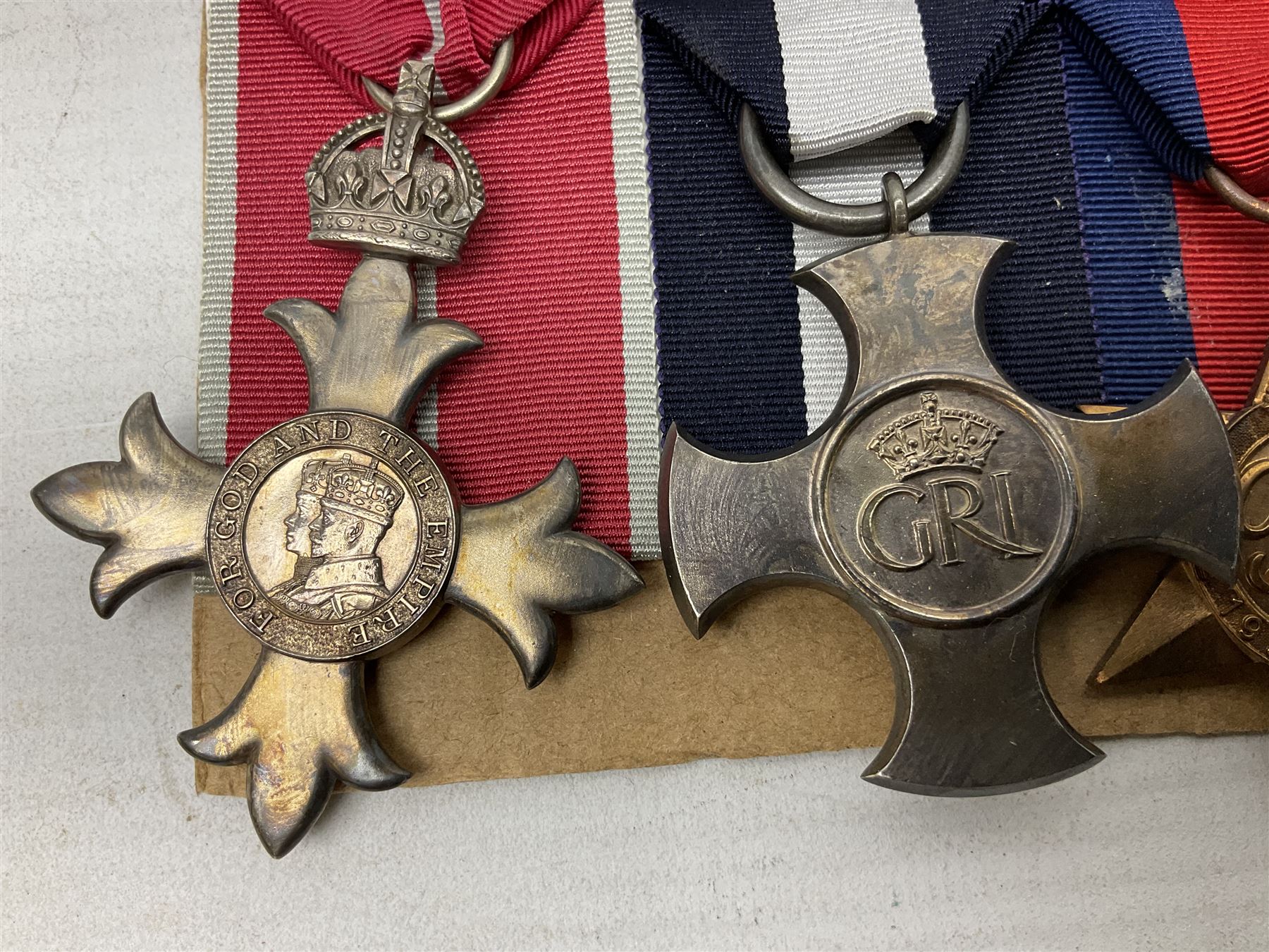 WW2 Royal Naval group of eight medals comprising OBE, hallmarked silver Distinguished Service Cross inscribed verso Lieut. J.R. McCluskie RNVR 1945, 1939-1945 Star, Atlantic Star, Africa Star, 1939-1945 War Medal, Defence Medal and Royal Naval Patrol Service Medal inscribed Lieutenant J.R. McCluskie Royal Naval Patrol Service; with seven original photographs of a sea battle 27th November 1940 against the Italian Fleet and another photographic postcard of Sir Stafford Cripps arriving on board one of the vessels.