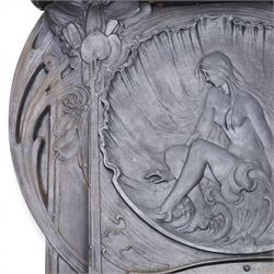 Art Nouveau cast iron fireplace, shaped hood with scrolling foliate crest, relief cast panel of female figure seated within shell form amidst wave motifs, uprights cast with foliate designs