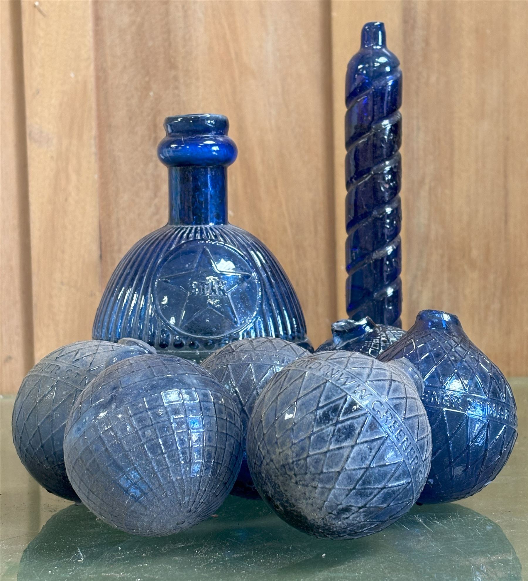 Collection of Victorian Bristol blue glass fire grenades, including an intact 'Star Hardens hand grenade fire extinguisher,' six smaller examples, some reading WW Greener, and a Minimax patent. (8) - COLLECTION BY APPOINTMENT FROM: The White House, Thirsk Road, Easingwold, York, YO61 3NF - CALL 01723 507111 TO ARRANGE