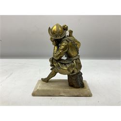 Brass figure of a knight seated up to a tree stump, upon a stepped base, H18cm 