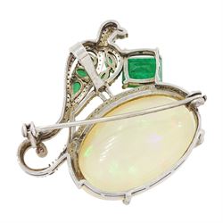 Silver opal, emerald, diamond and ruby bird pendant / brooch, emerald and diamond perched bird, on a single cabochon oval cut opal of approx 26.20 carat, total emerald weight approx 3.15 carat, total diamond weight approx 0.70 carat