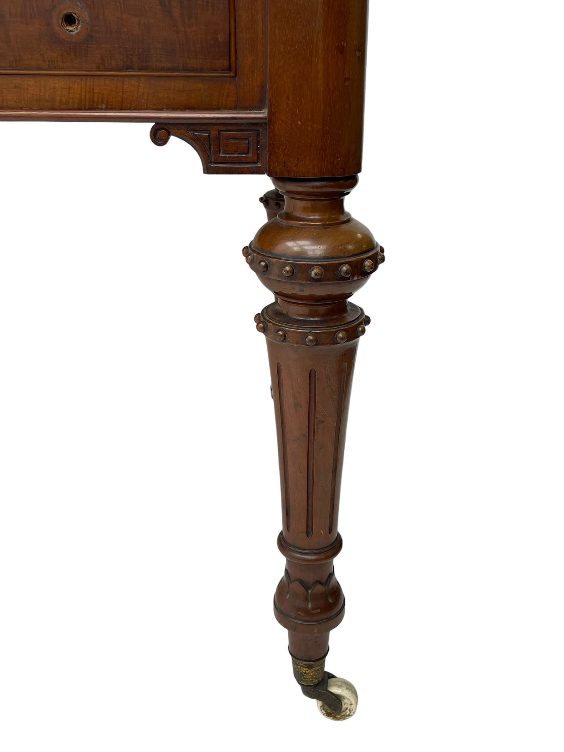 Victorian figured mahogany two-piece bedroom set - the washstand with white and black marble moulded top with arched back and raised shelf, two moulded frieze drawers, on turned and fluted supports with brass and ceramic castors (W123cm, D60cm, H102cm); the dressing table with raised swing mirror in moulded frame with shell and scroll carved pediment, on scrolled horns carved with foliage, four raised trinket drawers over moulded rectangular top, fitted with two drawers, on turned and fluted supports with brass and ceramic castors (W122cm, H177cm, D62cm)