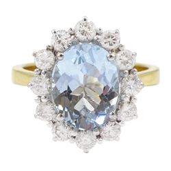  18ct gold oval cut aquamarine and round brilliant cut diamond cluster ring, hallmarked, aquamarine approx 2.55 carat, total diamond weight approx 0.85 carat