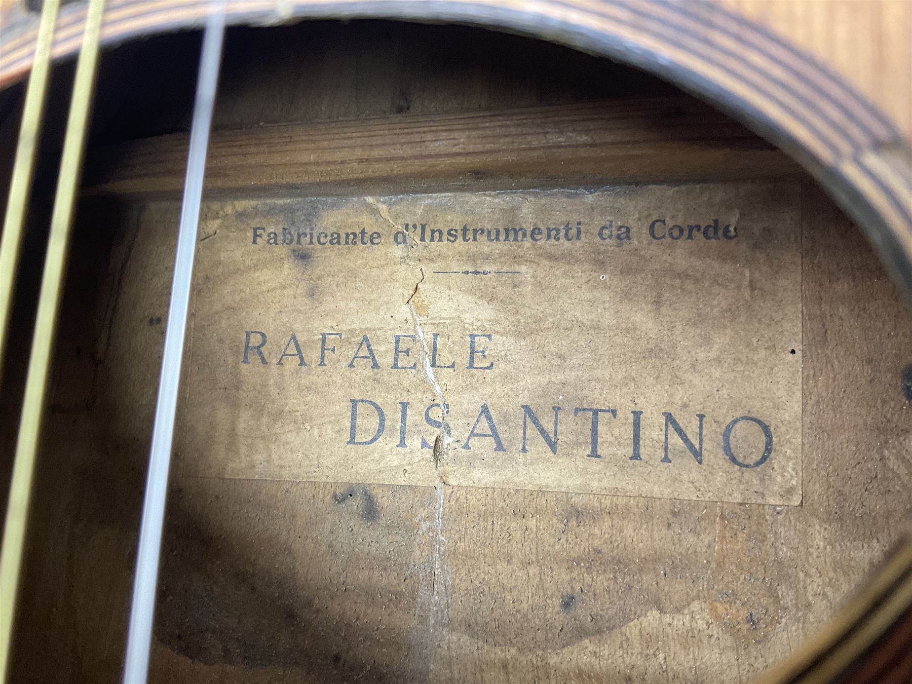Early 20th century Italian Rafaele Disantino eight-string mandolin with two-piece back and spruce top with stamped Rafaele Disantino signature; bears maker's label L61cm; in wooden carrying case