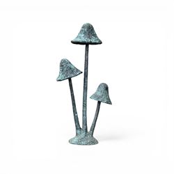 Bronze garden ornament in the form of three mushroom stalks, on naturalistic base