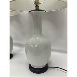 Pair of Chinese white crackle glazed table lamps, each of bottle form, raised upon circular hardwood bases, including shade H72cm
