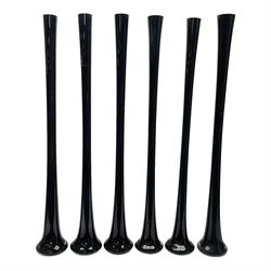 Six tall tapering cylindrical black glass vases, each with fluted rims, H90cm