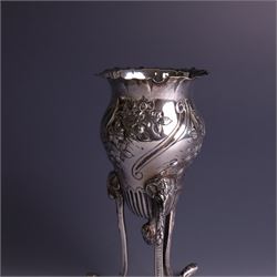 Late Victorian silver vase, of baluster form with fluted rim, the body with embossed floral decoration, upon three tall legs with ramshead mounts, hallmarked William Comyns & Sons, London 1890, H13.5cm