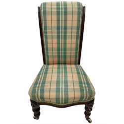 Small Victorian walnut framed nursing chair or doll's chair, upholstered in checkered fabric, turned front supports, brass and ceramic castors
