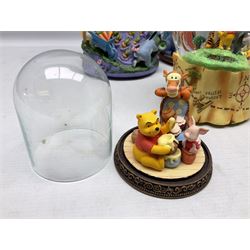 Five Disney Winnie The Pooh snow globes, to include Pooh and Piglet Sailing, Pooh's Grand Adventure and Blustery Day, together with The Walt Disney Classic Waterglobe collection globe and group Tigger, Winnie and Piglet figure under dome, all with boxes (7)