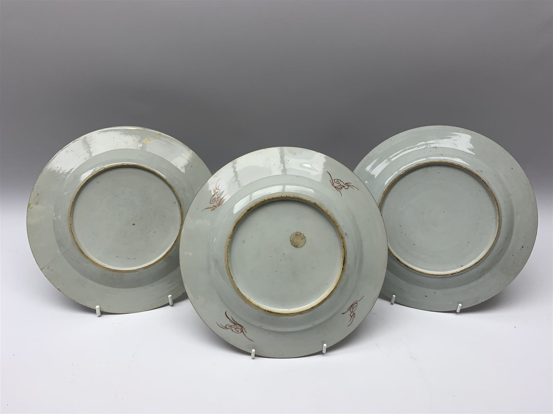 Three 18th Chinese plates, decorated in the Famille Rose pallet with various motifs including peonies, prunus blossom, willow, rockwork and fence, each approximately D13cm