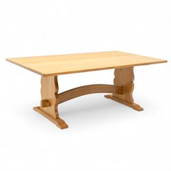 Unicornman - Yorkshire oak rectangular refectory style dining table by Coxwold cabinet maker Geoff Gell, rectangular top above trestle form base with broad scrolling outward outline, and heavy arched stretcher with Unicornman carved motif, traditional mortice and tenon pegged joints between the uprights