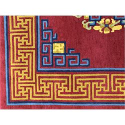 Tibetan-design handwoven rug, deep red field with three central medallions in yellow and blue, traditional yellow key border, white fringes on both ends
