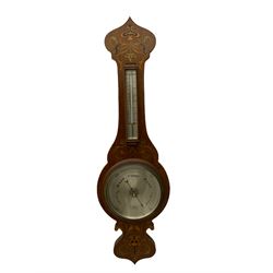 An early 20th century oak cased aneroid barometer in a decorative form with inlay in the arts and crafts style c1920, with a 7” silvered register indicating barometric pressure from 28 to 31 inches with predictions, steel indicating hand and brass recording hand, dial inscribed “Pearce & Sons, Leeds, York and Leicester” within a brass bezel and flat bevelled glass, detachable surface mounted mercury thermometer within a glazed box recording the temperature in degrees Fahrenheit and Celsius. 
Pearce & Son Jewellers are one of the county's longest established jewellers having been founded in 1838 by Mr. Henry Pearce, in Grantham, Lincolnshire, opening further shops in Huddersfield, Leeds, York and Leicester during the early 20th century.
	


