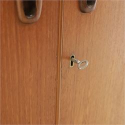 Turnbridge of London - Mid 20th century teak cocktail cabinet, with fold out top extending to 160cm, with twin doors revealing a shelved interior, the back with sliding glazed doors, raised on a recessed plinth base with castors