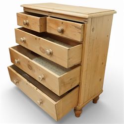 Victorian pine chest of drawers, with rounded top over two short and three long drawers fitted with turned wooden knob handles, raised on turned bun feet