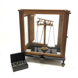 Set of cased brass and chrome laboratory scales by J.W. Towers Widnes Model 75, with black vitrolite type base, upward sliding front and hinged side doors, W40cm H47cm; with bakelite cased set of weights by ETA Instruments Ltd