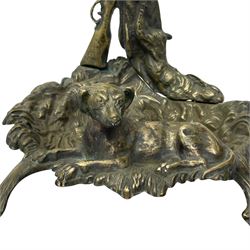 Pair of cast brass hallway umbrella or stick stands, in the form of a tree decorated with trailing flowering foliage branches, the stem with hunting horn over leaning shotgun, shaped naturalist tray base with hunting hound and out splayed foliate cast feet 