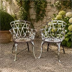 Pair of late 19th century painted cast iron garden chairs, open scroll and heart backs, or...