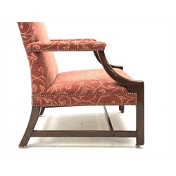 Georgian mahogany Gainsborough open armchair, serpentine cresting rail, upholstered in pale red fabric decorated with scrolled interlacing floral pattern, down curved arm supports, moulded front supports with chamfered inner edge, brass and leather castor, W72cm (max), H99cm, seat width - 61cm, seat height - 40cm