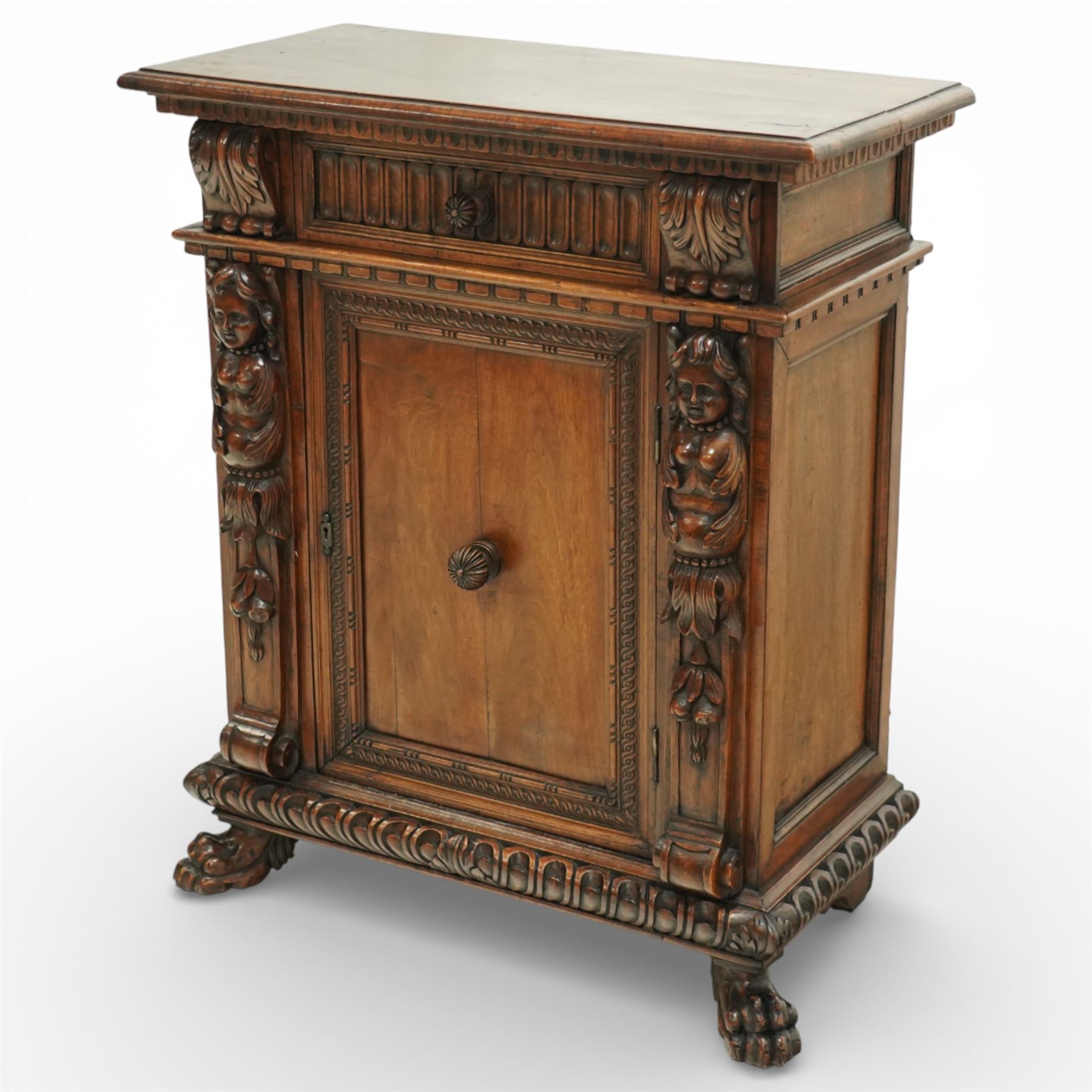 19th century Italian walnut Renaissance Revival side cabinet, the moulded rectangular top above a frieze drawer carved with vertical fluting and a central rosette, with egg-and-dart moulded rails to the top and base, acanthus-carved corbels below, the panelled cupboard door framed by beading and guilloche ornament, flanked by carved caryatids modelled as classical female architectural supports with foliate terminals, raised on paw feet