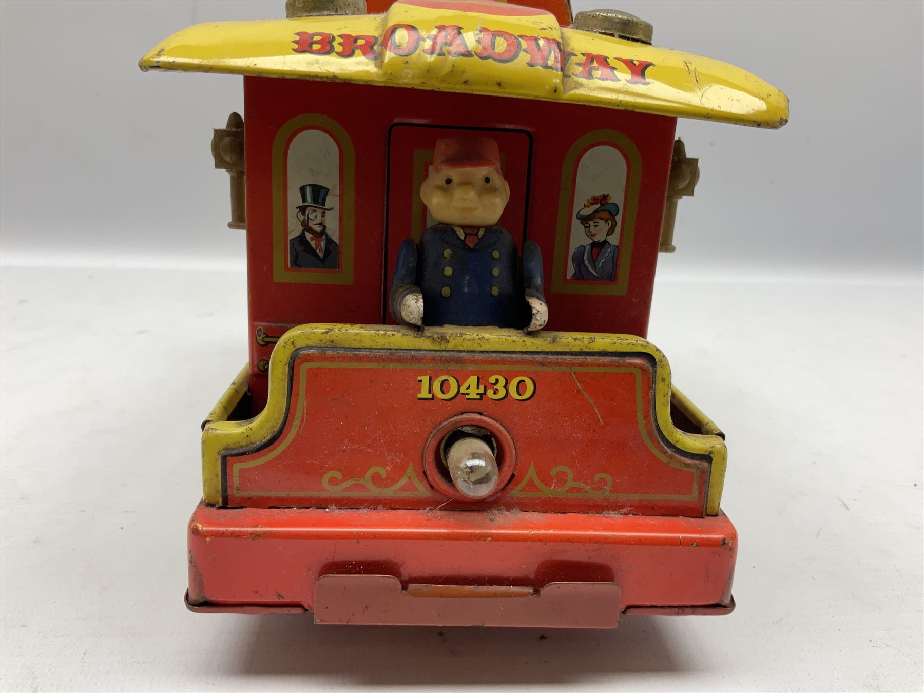 Chad Valley '0' gauge - clockwork tin-plate train set comprising LMS 0-4-0 tender locomotive No.3402 with two open wagons, loop of track and wooden signal; unboxed; and Japanese battery operated tin-plate Broadway Trolley bus No.10430